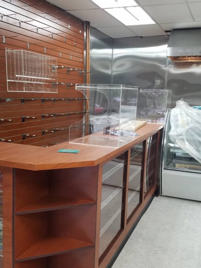 Retail checkout desk with glass and slatwall and register cover