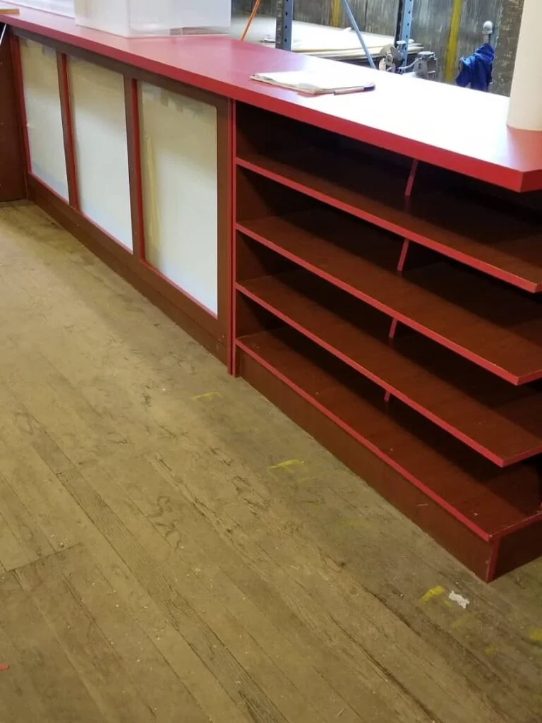 Commercial coffee counter with shelves and white doors